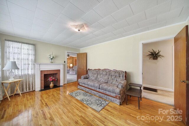 2084 Old Evans Cir, Lancaster, SC 29720 - living room with wood-type flooring, a brick fireplace, and crown molding