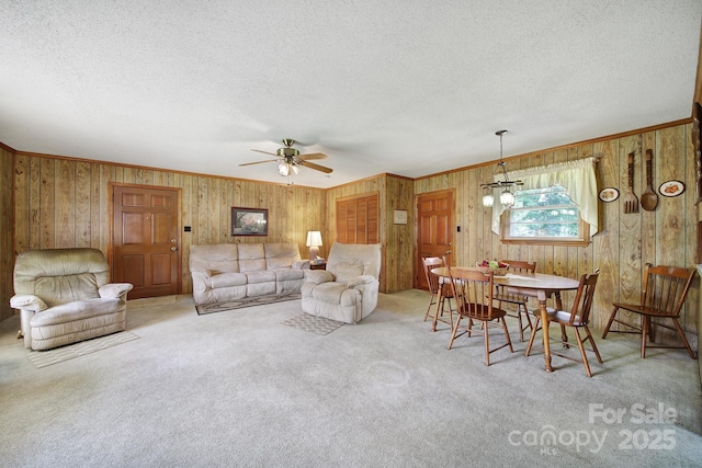 2084 Old Evans Cir, Lancaster, SC 29720 - carpeted living area with a textured ceiling, ceiling fan, wood walls, and ornamental molding