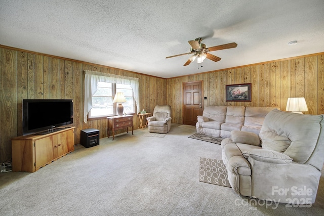 2084 Old Evans Cir, Lancaster, SC 29720 - living area featuring a ceiling fan, wood walls, a textured ceiling, light carpet, and crown molding
