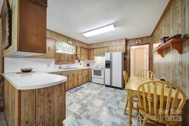 2084 Old Evans Cir, Lancaster, SC 29720 - kitchen featuring white appliances, wood walls, ornamental molding, light countertops, and open shelves