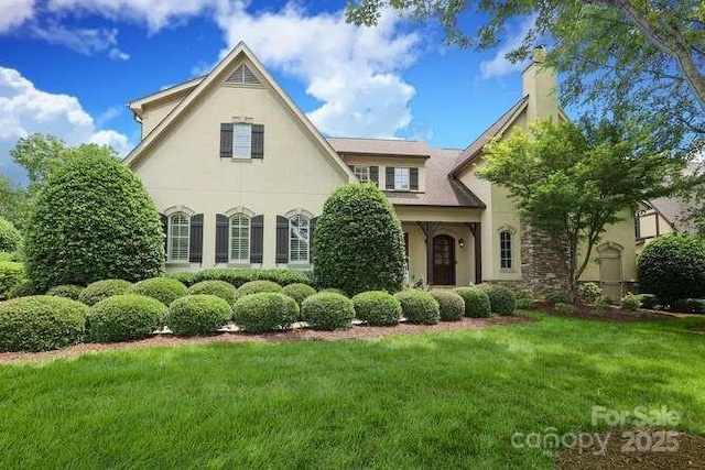 1103 Mapesbury Ln, Waxhaw, NC 28173 - view of front facade with a front yard, a chimney, and stucco siding