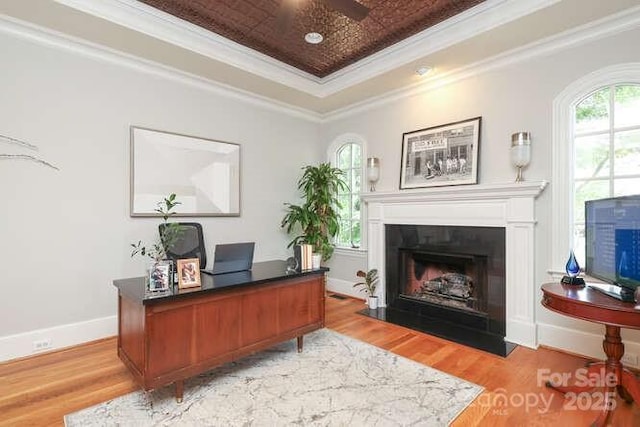 1103 Mapesbury Ln, Waxhaw, NC 28173 - office space featuring a fireplace with flush hearth, light wood-style flooring, crown molding, and a tray ceiling