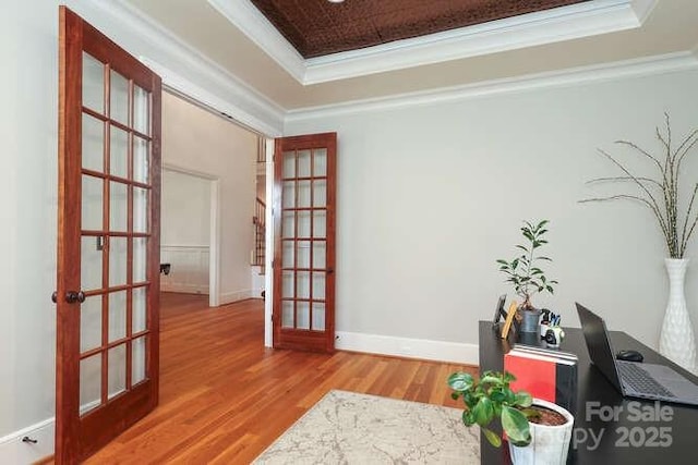1103 Mapesbury Ln, Waxhaw, NC 28173 - living area with french doors, a raised ceiling, crown molding, wood finished floors, and baseboards