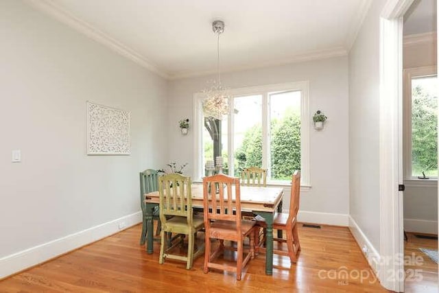 1103 Mapesbury Ln, Waxhaw, NC 28173 - dining room with ornamental molding, baseboards, light wood-type flooring, and a chandelier