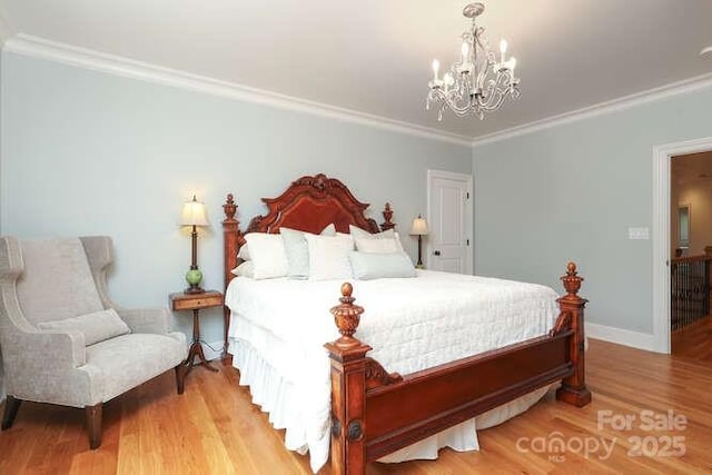 1103 Mapesbury Ln, Waxhaw, NC 28173 - bedroom featuring a chandelier, crown molding, light wood-style flooring, and baseboards