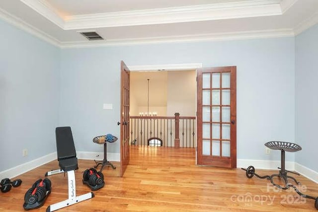 1103 Mapesbury Ln, Waxhaw, NC 28173 - workout room with a raised ceiling, wood finished floors, crown molding, and baseboards