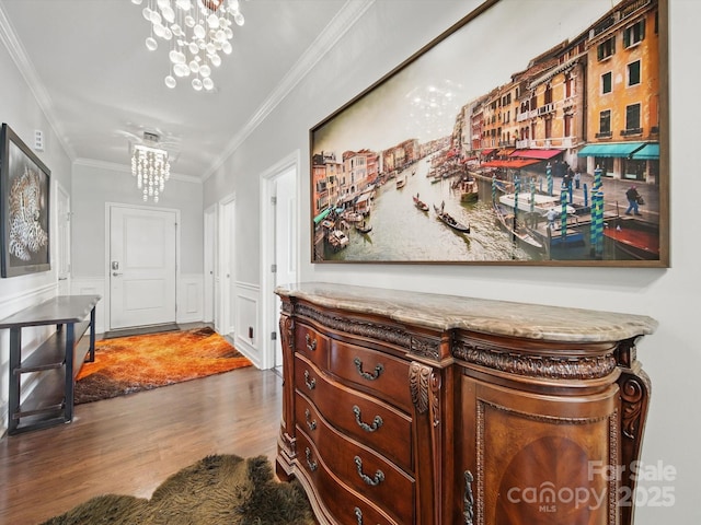 11225 Island View Ln, Lancaster, SC 29720 - hallway with wood finished floors, a chandelier, ornamental molding, and a wainscoted wall
