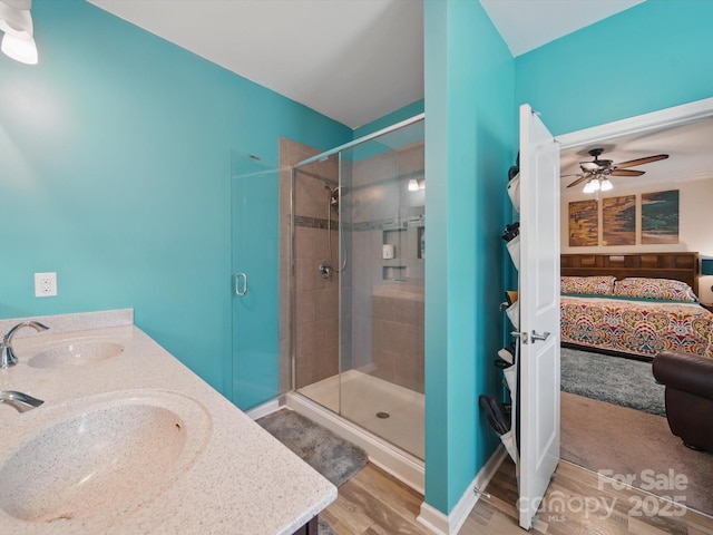 11225 Island View Ln, Lancaster, SC 29720 - ensuite bathroom with a stall shower, wood finished floors, double vanity, and a ceiling fan