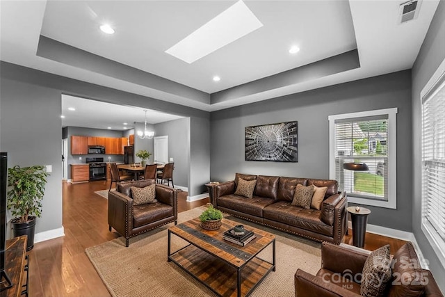 6 Meeting St, Asheville, NC 28803 - living room featuring a tray ceiling, baseboards, recessed lighting, and wood finished floors