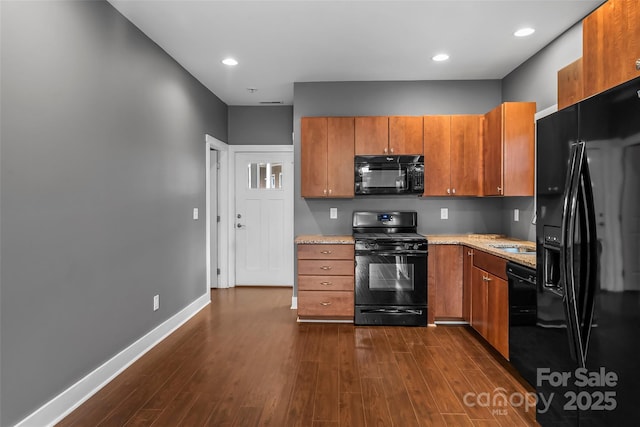 6 Meeting St, Asheville, NC 28803 - kitchen featuring black appliances, brown cabinets, dark wood-type flooring, baseboards, and recessed lighting