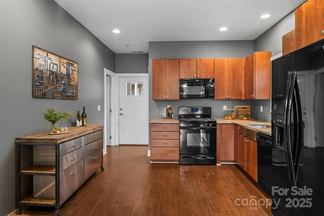 6 Meeting St, Asheville, NC 28803 - kitchen with black appliances, brown cabinetry, light countertops, dark wood-style floors, and recessed lighting