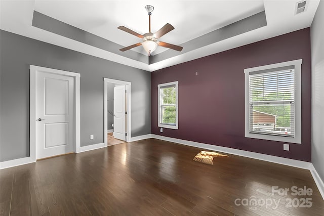 6 Meeting St, Asheville, NC 28803 - unfurnished bedroom with a raised ceiling, baseboards, wood finished floors, and a ceiling fan