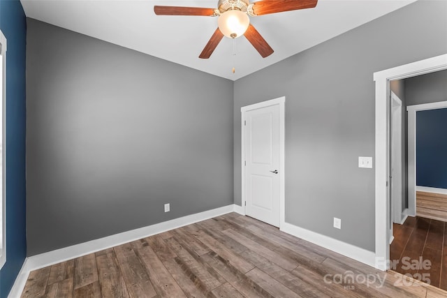 6 Meeting St, Asheville, NC 28803 - unfurnished bedroom with wood finished floors, baseboards, and ceiling fan