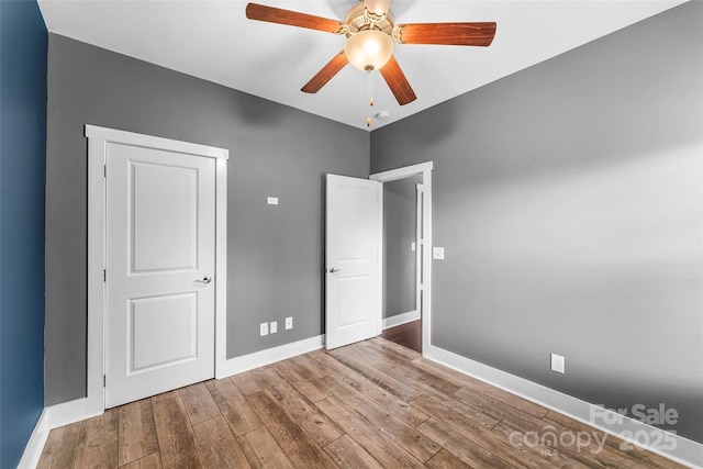 6 Meeting St, Asheville, NC 28803 - unfurnished bedroom with baseboards, hardwood / wood-style floors, and ceiling fan