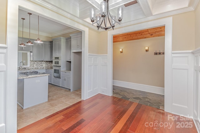 135 Waycross Dr, Rockwell, NC 28110 - kitchen featuring gray cabinets, a chandelier, stainless steel appliances, light wood-style flooring, and crown molding