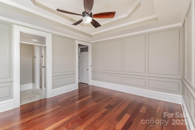 135 Waycross Dr, Rockwell, NC 28110 - unfurnished bedroom with a decorative wall, dark wood finished floors, crown molding, a raised ceiling, and a ceiling fan
