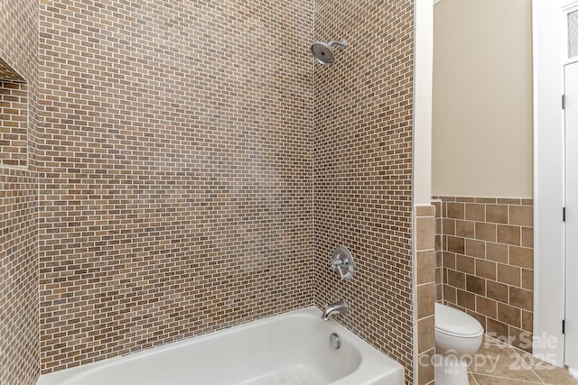 135 Waycross Dr, Rockwell, NC 28110 - full bathroom featuring toilet, tile walls, tub / shower combination, and tile patterned floors