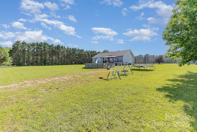 135 Waycross Dr, Rockwell, NC 28110 - view of grassy yard with a trampoline and a playground