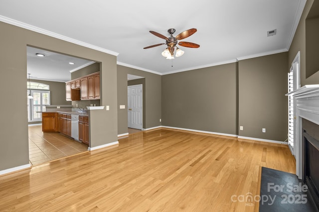10455 Alexander Martin Ave, Charlotte, NC 28277 - unfurnished living room with ceiling fan, ornamental molding, light wood-type flooring, a fireplace with flush hearth, and baseboards