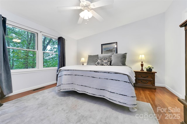 500 Cheestoonaya Way, Brevard, NC 28712 - bedroom with wood finished floors, baseboards, vaulted ceiling, and ceiling fan
