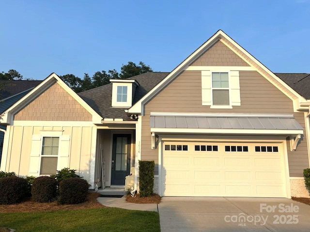 1636 Sand Harbor Cir, Ocean Isle Beach, NC 28469 - view of front of home with concrete driveway, a standing seam roof, a shingled roof, and metal roof