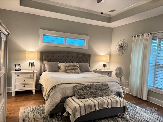 1636 Sand Harbor Cir, Ocean Isle Beach, NC 28469 - bedroom with dark wood-style flooring, baseboards, a tray ceiling, and ornamental molding