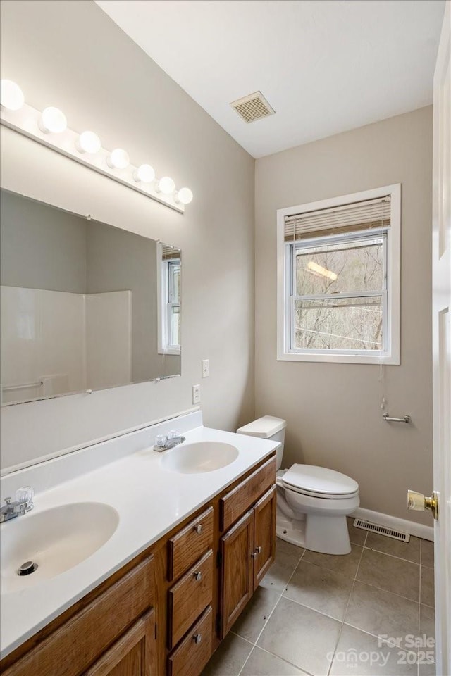 2599/2611 Old Mars Hill Hwy, Weaverville, NC 28787 - bathroom featuring double vanity, toilet, tile patterned floors, and baseboards