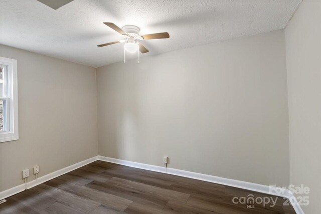 2599/2611 Old Mars Hill Hwy, Weaverville, NC 28787 - spare room featuring dark wood-type flooring, a ceiling fan, baseboards, and a textured ceiling