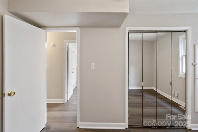2599/2611 Old Mars Hill Hwy, Weaverville, NC 28787 - unfurnished bedroom featuring wood finished floors, baseboards, and a closet