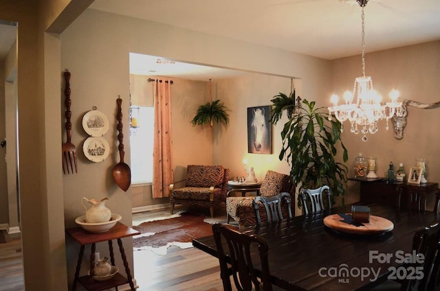 7170 Kenyon Dr, Denver, NC 28037 - dining space featuring wood finished floors and a chandelier