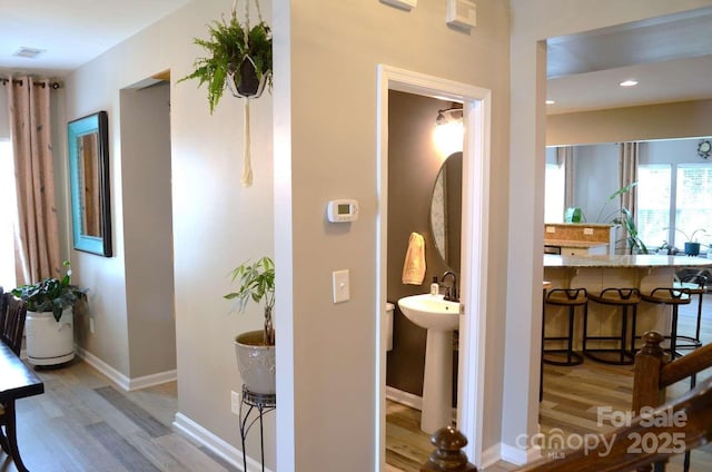 7170 Kenyon Dr, Denver, NC 28037 - hallway featuring light wood finished floors, baseboards, and recessed lighting