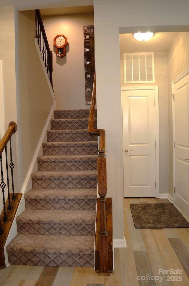 7170 Kenyon Dr, Denver, NC 28037 - entryway with stairway, wood finished floors, and baseboards