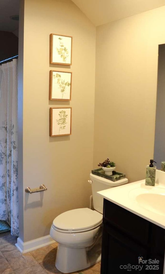 7170 Kenyon Dr, Denver, NC 28037 - full bathroom featuring vanity, toilet, baseboards, and a shower with curtain