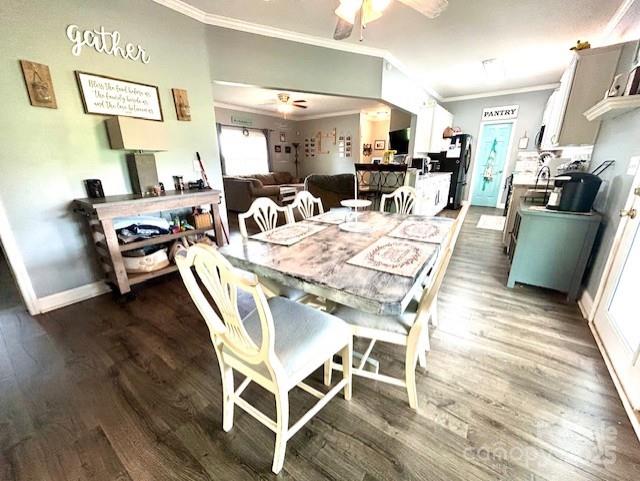 1545 Lewis Farm Rd, Kings Mountain, NC 28086 - dining space with ornamental molding, ceiling fan, dark wood-type flooring, and baseboards