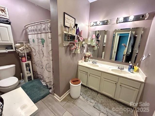 1545 Lewis Farm Rd, Kings Mountain, NC 28086 - full bathroom featuring double vanity, toilet, tile patterned floors, and a shower with curtain