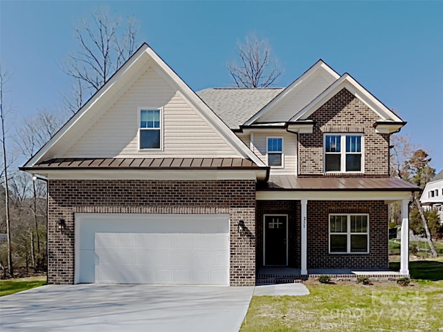 231 Brook Ave SE, Concord, NC 28025 - view of front of home with brick siding, a porch, a standing seam roof, and driveway