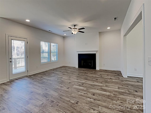 231 Brook Ave SE, Concord, NC 28025 - unfurnished living room with wood finished floors, ceiling fan, recessed lighting, a fireplace, and baseboards