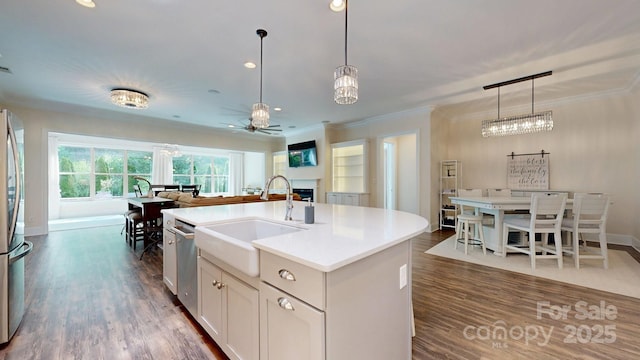 5590 Elk Knob Ct, Denver, NC 28037 - kitchen featuring a fireplace, ceiling fan, dark wood-style flooring, crown molding, and pendant lighting