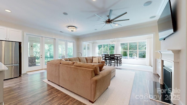 5590 Elk Knob Ct, Denver, NC 28037 - living room featuring crown molding, wood finished floors, a ceiling fan, recessed lighting, and a fireplace