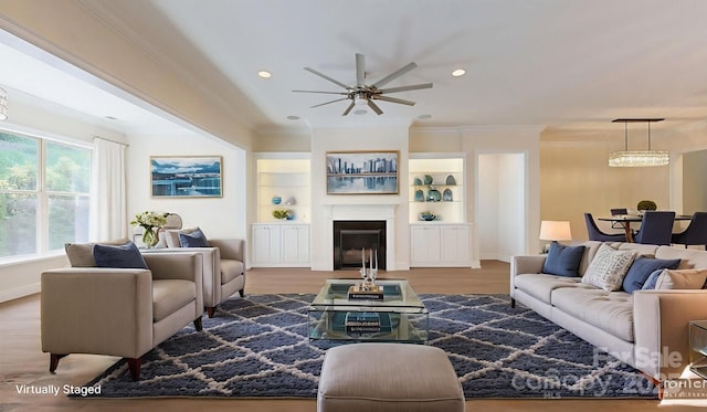 5590 Elk Knob Ct, Denver, NC 28037 - living area featuring a ceiling fan, ornamental molding, wood finished floors, a glass covered fireplace, and recessed lighting