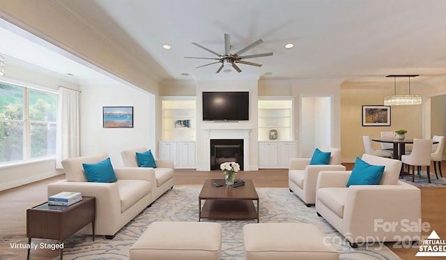 5590 Elk Knob Ct, Denver, NC 28037 - living room with light wood-style floors, ornamental molding, a ceiling fan, a glass covered fireplace, and recessed lighting