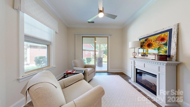5590 Elk Knob Ct, Denver, NC 28037 - living room with plenty of natural light, crown molding, a glass covered fireplace, wood finished floors, and a ceiling fan