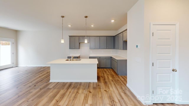 2547 Ruby Dixon Crossing Dr Unit 17, Gastonia, NC 28056 - kitchen featuring gray cabinetry, light wood-style floors, recessed lighting, decorative light fixtures, and an island with sink
