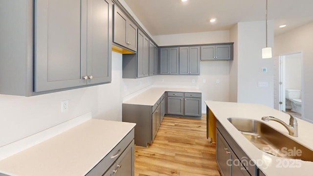 2547 Ruby Dixon Crossing Dr Unit 17, Gastonia, NC 28056 - kitchen with gray cabinets, decorative light fixtures, light wood finished floors, recessed lighting, and light countertops
