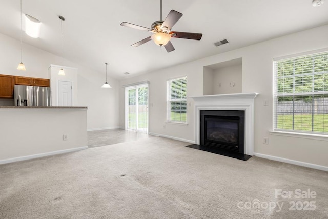4714 Adamshire Ave, Concord, NC 28025 - unfurnished living room with light carpet, lofted ceiling, plenty of natural light, a fireplace with flush hearth, and ceiling fan