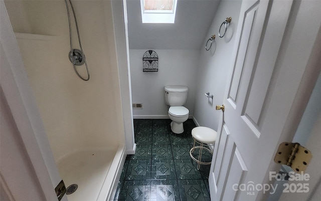 253 Nors Way Unit 26, Lake Lure, NC 28746 - full bathroom with toilet, a stall shower, vaulted ceiling, baseboards, and tile patterned flooring