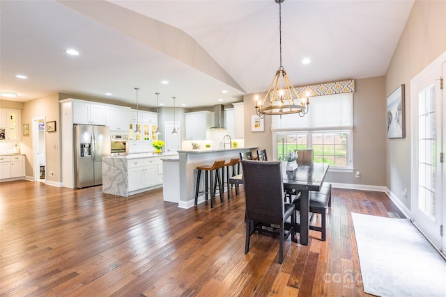 1868 Chestnut Hill Dr, Tega Cay, SC 29708 - dining space with a chandelier, dark wood-type flooring, baseboards, vaulted ceiling, and recessed lighting