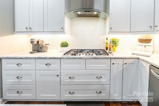 1868 Chestnut Hill Dr, Tega Cay, SC 29708 - kitchen featuring wall chimney range hood, appliances with stainless steel finishes, tasteful backsplash, and white cabinets