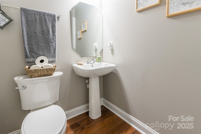 1868 Chestnut Hill Dr, Tega Cay, SC 29708 - half bathroom with toilet, wood finished floors, baseboards, and a sink