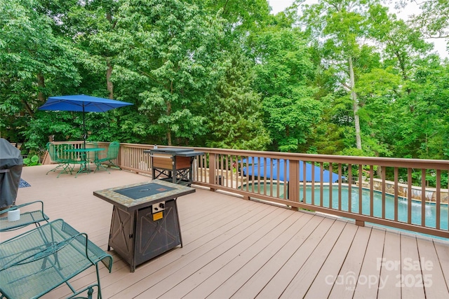 1868 Chestnut Hill Dr, Tega Cay, SC 29708 - wooden deck featuring outdoor dining area and view of wooded area